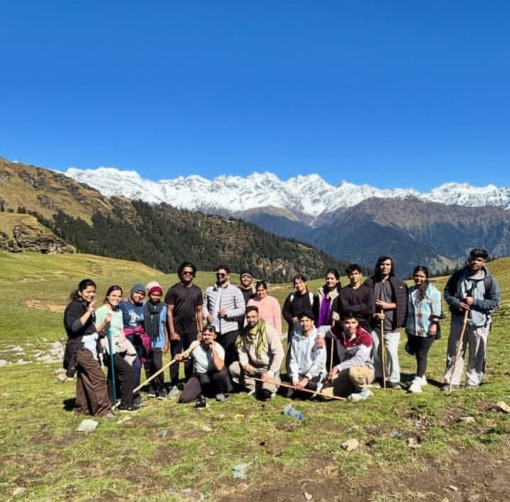Group on a mountain ridge with snow peaks