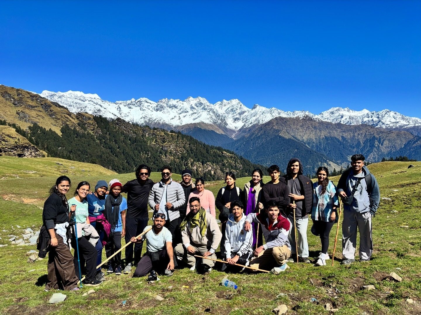 Group photo on a high meadow with snow mountains
